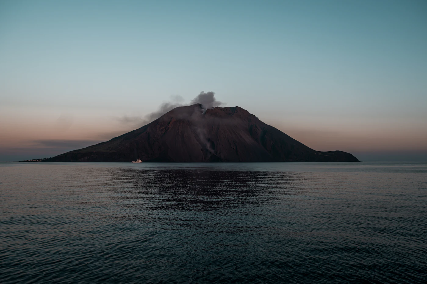 The outline of Stromboli over the sea at sunset
