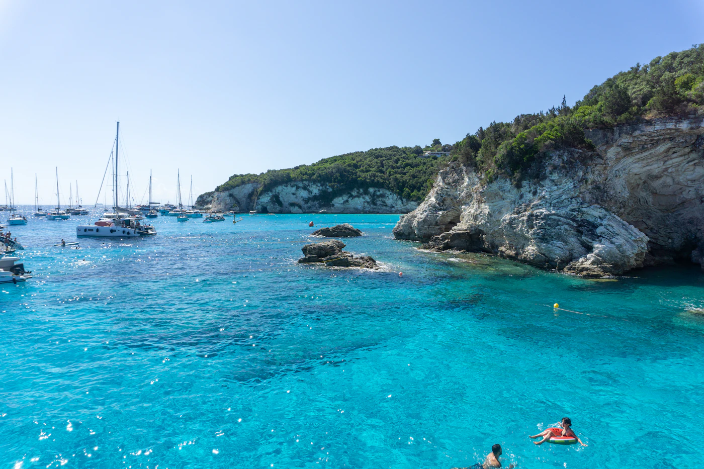 Sailing yacht in a cove among the rocks