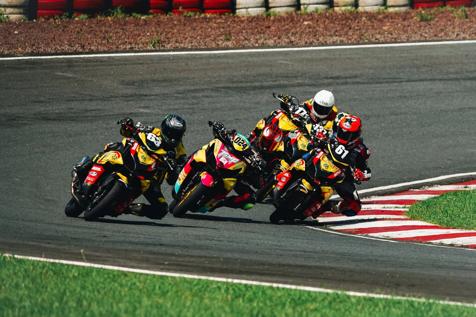 Groupe de motos penchées à l’entrée d’un virage